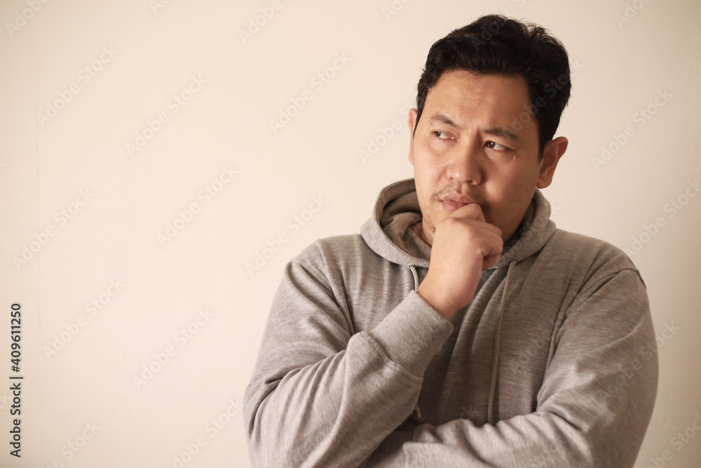 Sad depressed anxiety Asian man thinking contemplating bad thing happened in his life, stress exhausted feeling down expression, financial or relationship problem Sad depressed anxiety Asian man thinking contemplating bad thing happened in his life, stress exhausted feeling down expression, financial or relationship problem