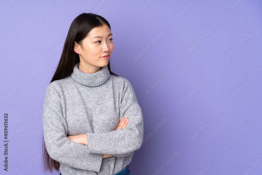 Young asian woman over isolated background looking to the side Young asian woman over isolated background looking to the side