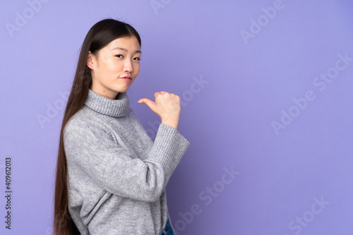 Young asian woman over isolated background proud and self-satisfied