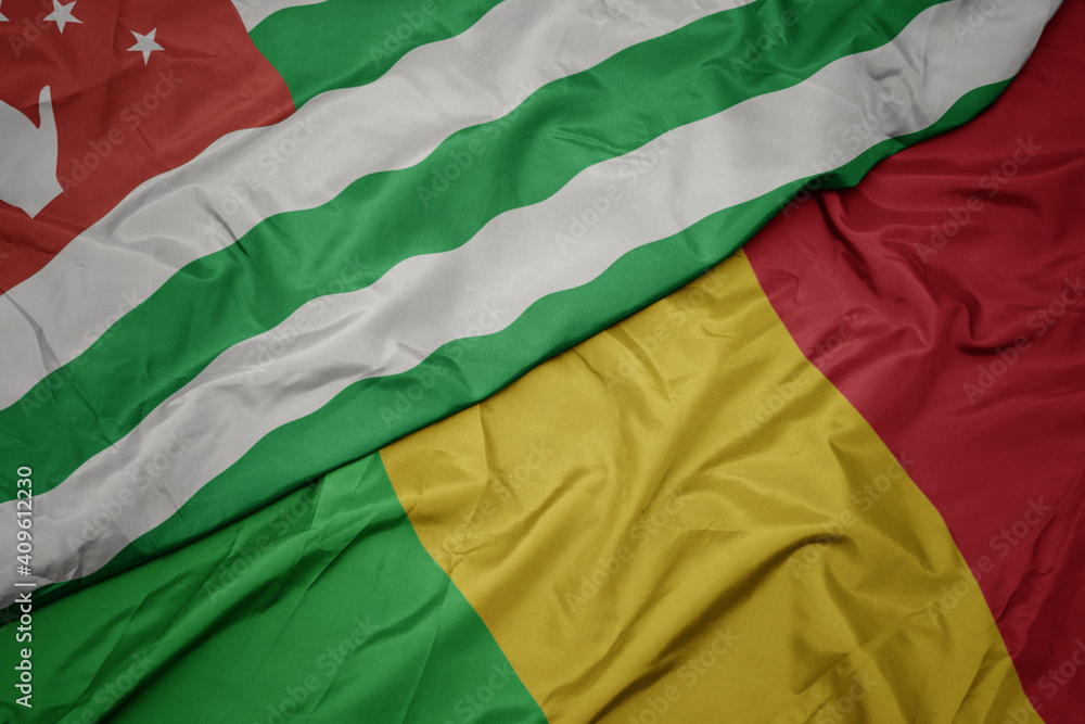 waving colorful flag of mali and national flag of abkhazia.