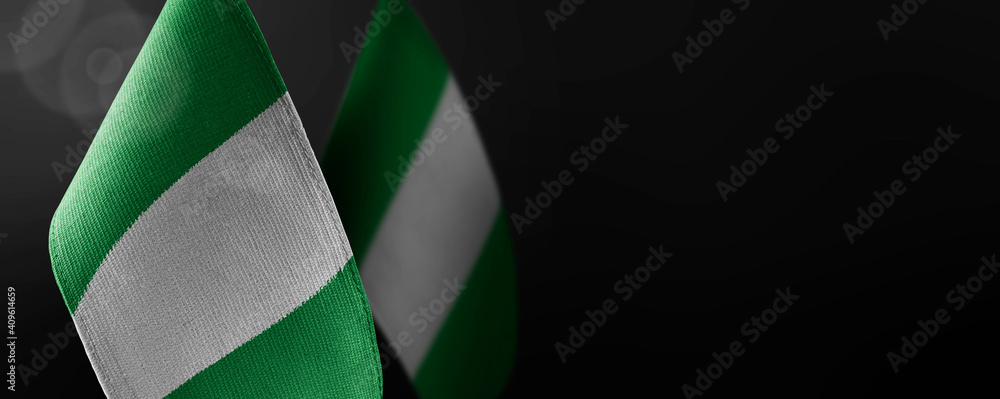 Obraz premium Small national flags of the Nigeria on a dark background