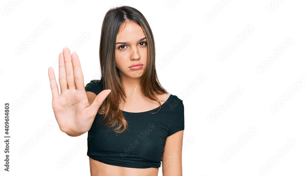Young brunette woman wearing casual clothes doing stop sing with palm of the hand. warning expression with negative and serious gesture on the face. Young brunette woman wearing casual clothes doing stop sing with palm of the hand. warning expression with negative and serious gesture on the face.