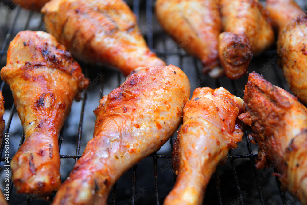 
marinated chicken drumstick is fried over coals with spices and herbs.