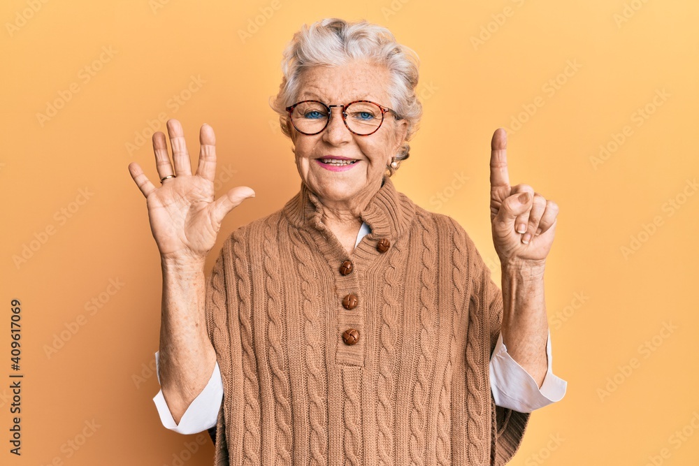 Senior grey-haired woman wearing casual clothes and glasses showing and pointing up with fingers number six while smiling confident and happy. Senior grey-haired woman wearing casual clothes and glasses showing and pointing up with fingers number six while smiling confident and happy.