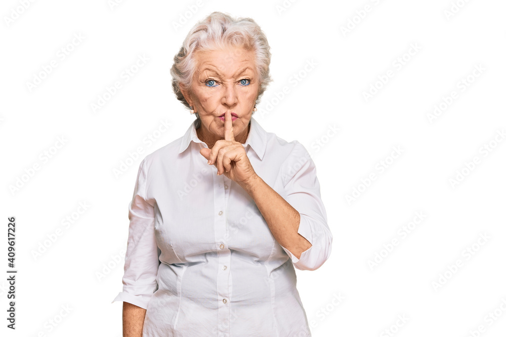 Senior grey-haired woman wearing casual clothes asking to be quiet with finger on lips. silence and secret concept.