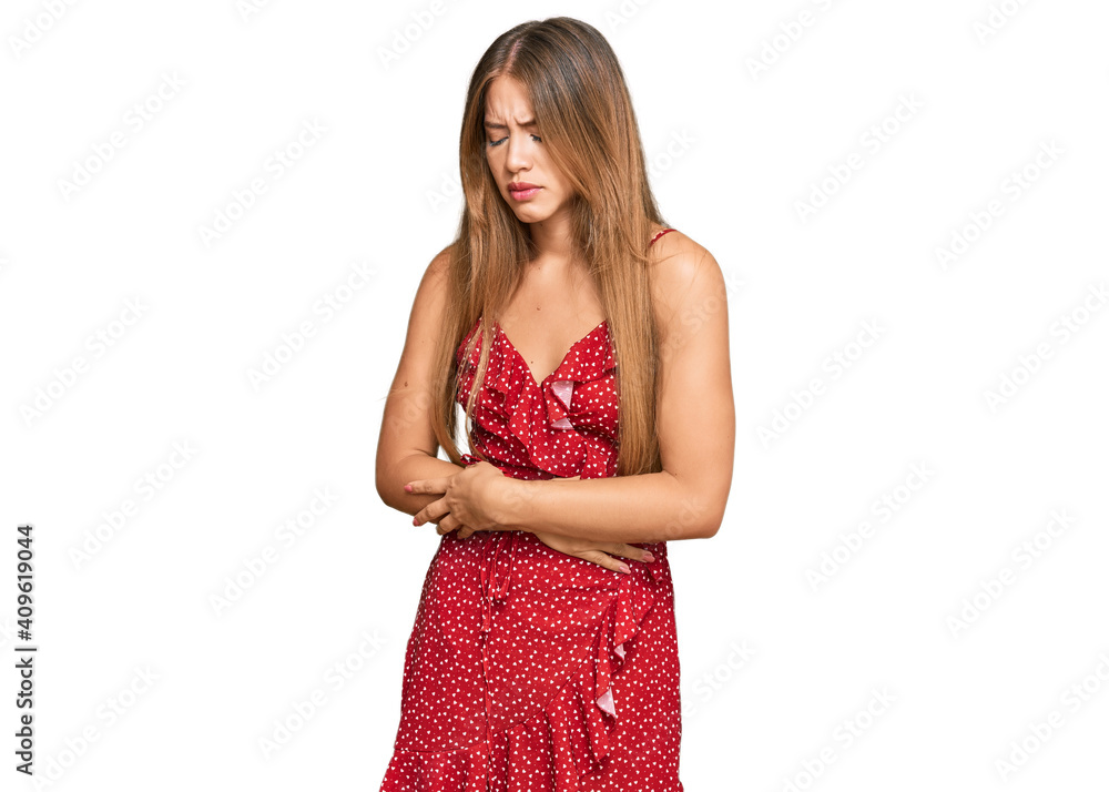Beautiful blonde woman wearing summer dress with hand on stomach because indigestion, painful illness feeling unwell. ache concept.