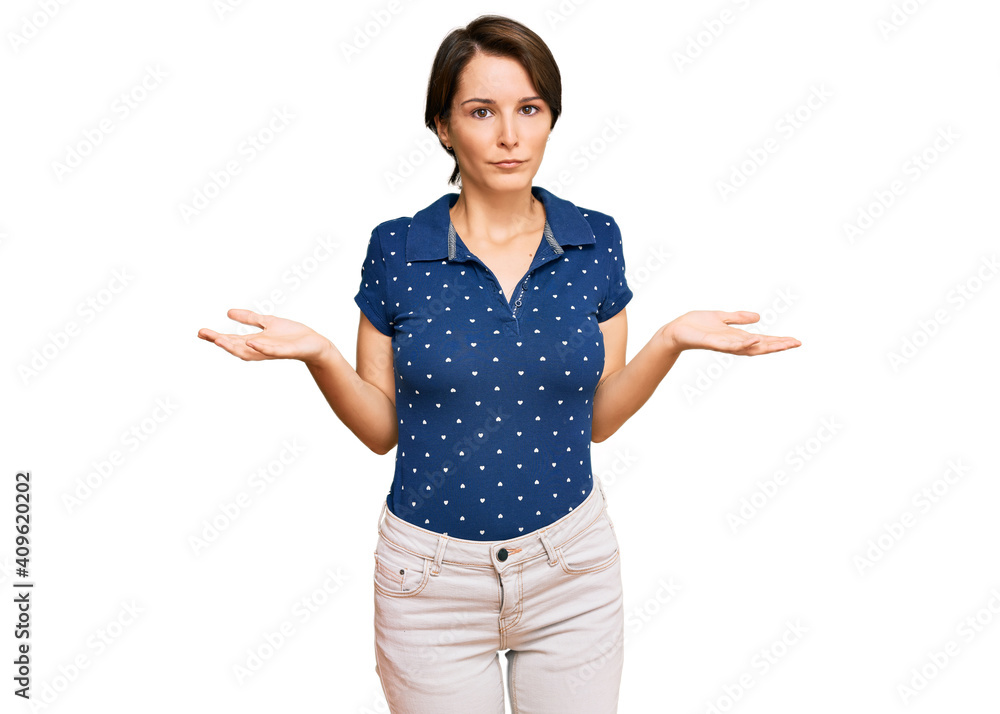 Young brunette woman with short hair wearing casual clothes clueless and confused expression with arms and hands raised. doubt concept. Young brunette woman with short hair wearing casual clothes clueless and confused expression with arms and hands raised. doubt concept.
