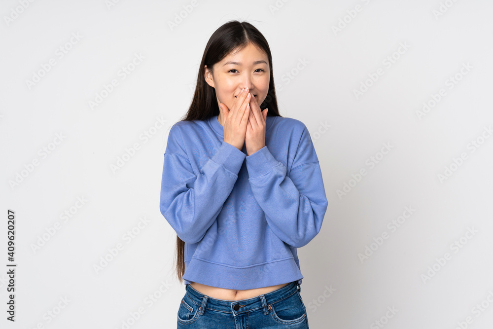 Young asian woman isolated on background happy and smiling covering mouth with hands Young asian woman isolated on background happy and smiling covering mouth with hands
