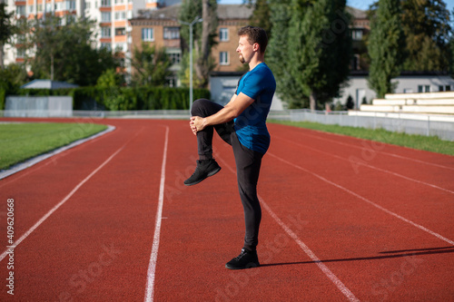 Handsome guy doing stretching during workout