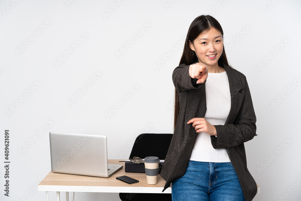 Business asian woman in her workplace isolated on white background points finger at you with a confident expression Business asian woman in her workplace isolated on white background points finger at you with a confident expression