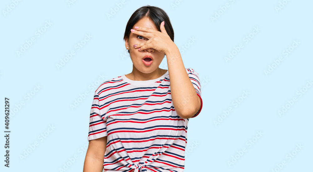 Beautiful young woman with short hair wearing casual clothes peeking in shock covering face and eyes with hand, looking through fingers with embarrassed expression. Beautiful young woman with short hair wearing casual clothes peeking in shock covering face and eyes with hand, looking through fingers with embarrassed expression.