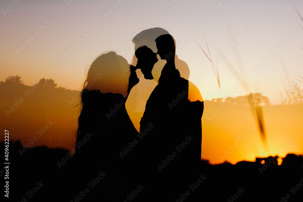 Silhouette of a woman and a man at sunset.