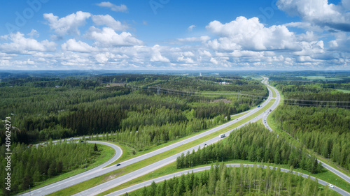 Summer rural landscape, aerial view. View of green forest and highway. Finland.
