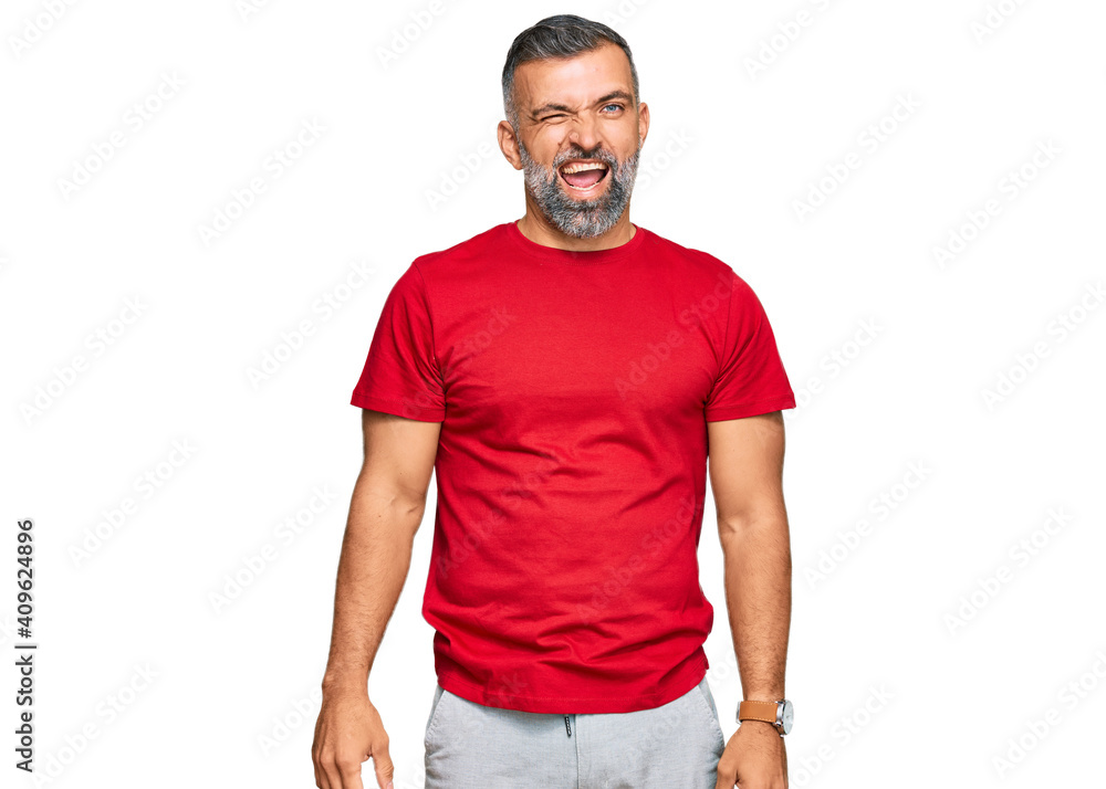 Middle age handsome man wearing casual clothes winking looking at the camera with sexy expression, cheerful and happy face. Middle age handsome man wearing casual clothes winking looking at the camera with sexy expression, cheerful and happy face.