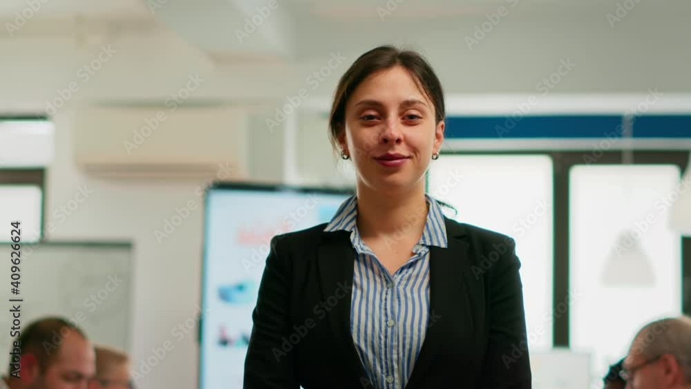 Woman entrepreneur smiling at camera standing in conference room, preparing for meeting with partners. Project manager working in professional start up financial business ready for brainstorming Woman entrepreneur smiling at camera standing in conference room, preparing for meeting with partners. Project manager working in professional start up financial business ready for brainstorming