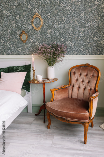 Brown armchair next to a table with flowers