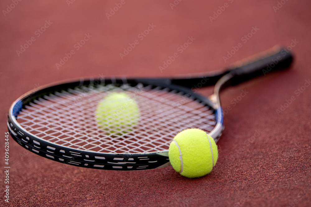 Close up. Tennis racket and balls on court