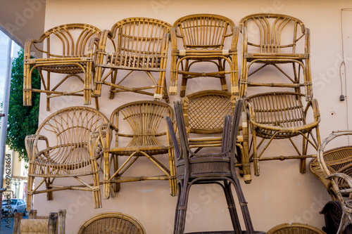 Old chairs of natural woven straw on the wall © romaset