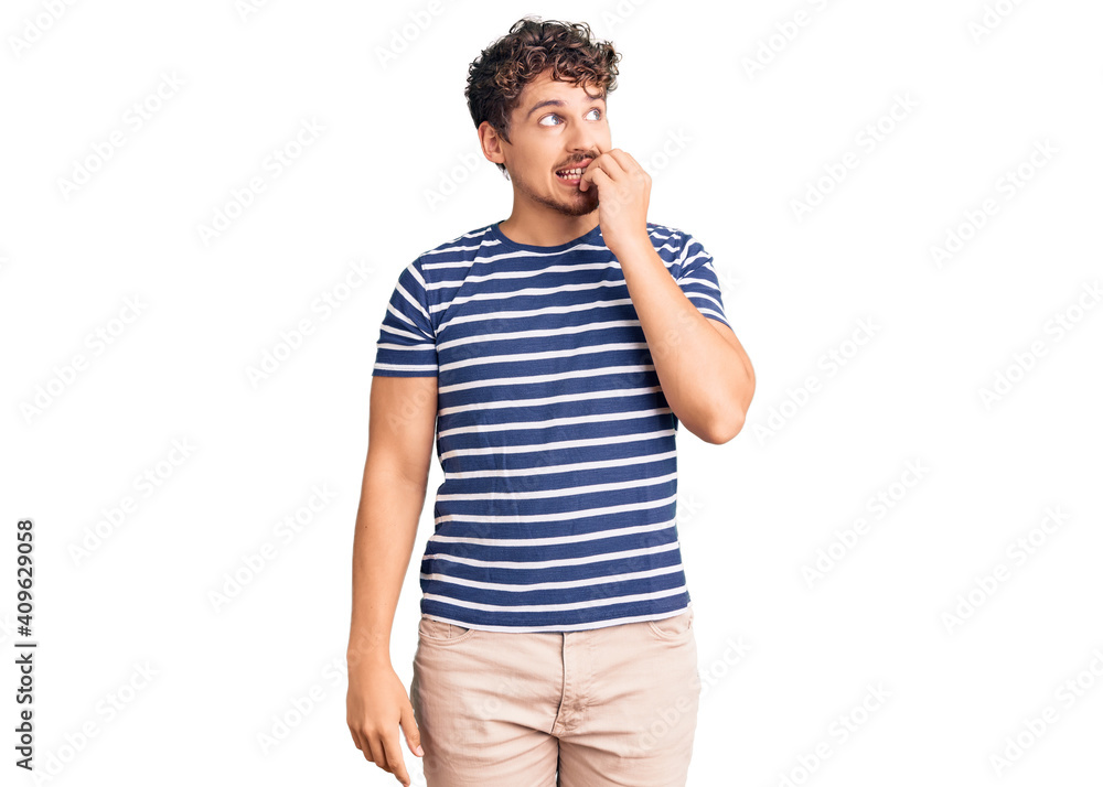 Young handsome man with curly hair wearing casual clothes looking stressed and nervous with hands on mouth biting nails. anxiety problem. Young handsome man with curly hair wearing casual clothes looking stressed and nervous with hands on mouth biting nails. anxiety problem.