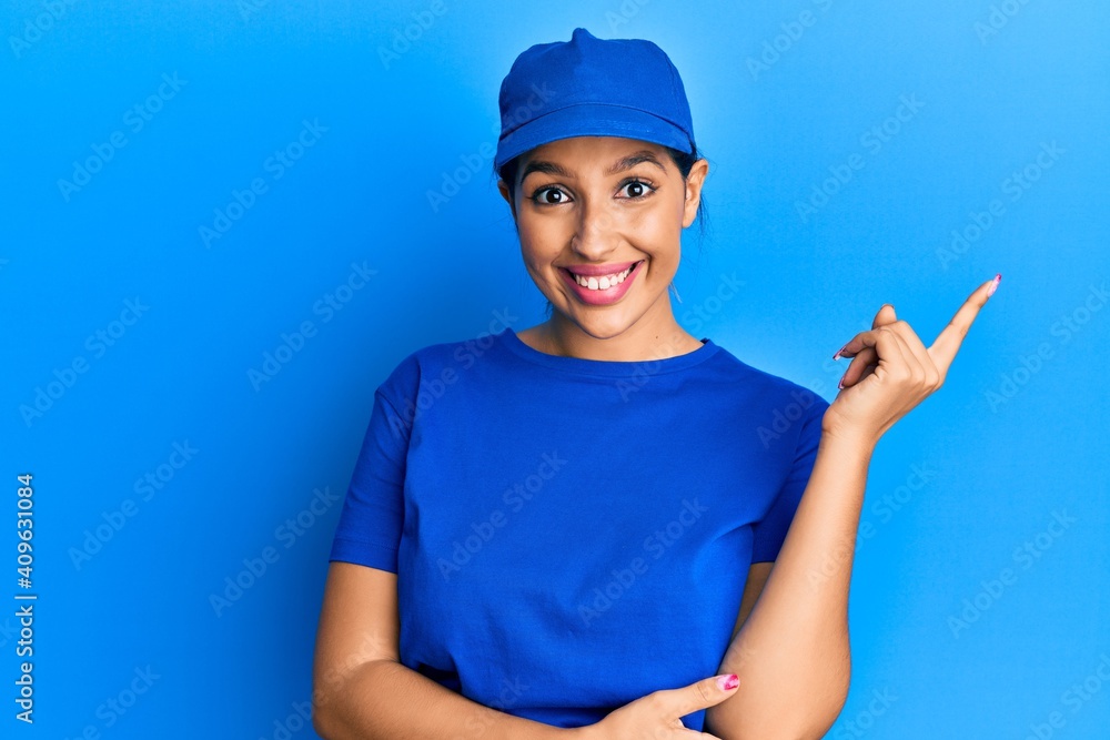 Beautiful brunette woman wearing delivery uniform smiling happy pointing with hand and finger to the side Beautiful brunette woman wearing delivery uniform smiling happy pointing with hand and finger to the side
