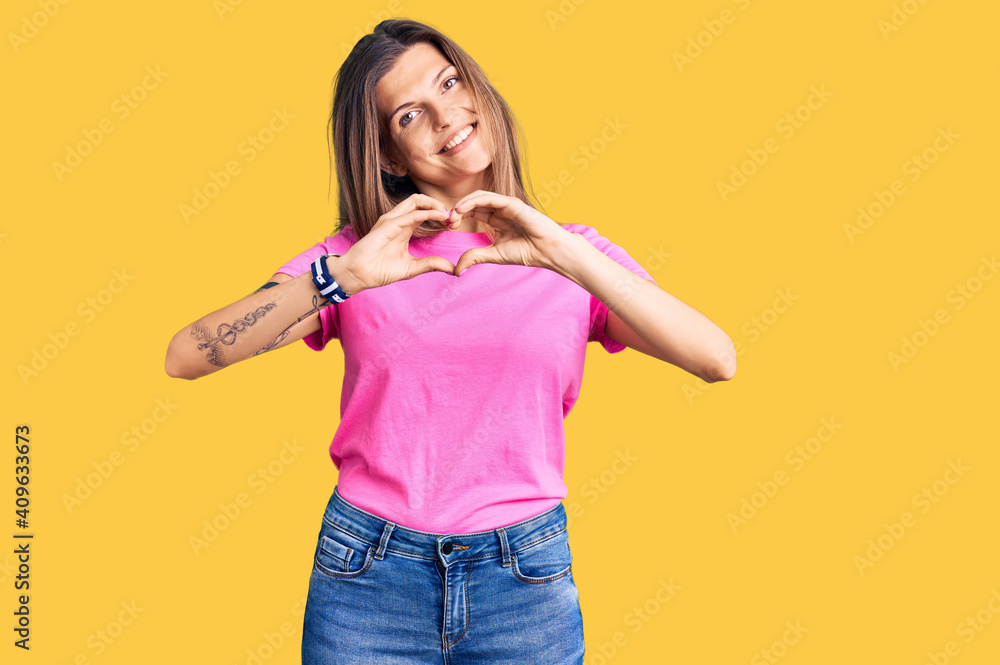 Beautiful caucasian woman wearing casual clothes smiling in love doing heart symbol shape with hands. romantic concept. Beautiful caucasian woman wearing casual clothes smiling in love doing heart symbol shape with hands. romantic concept.