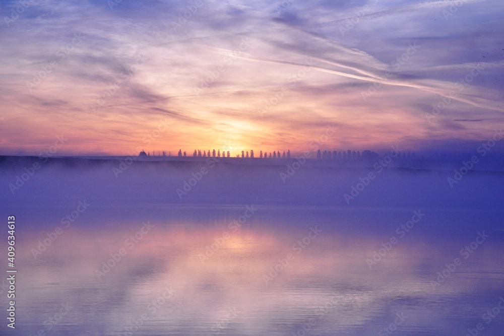 Misty beautiful sunrise over water Misty beautiful sunrise over water