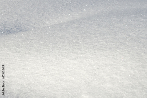 White snow texture on clear day. Winter background. Snow drifts. white snowflakes background, rough pattern of snow texture