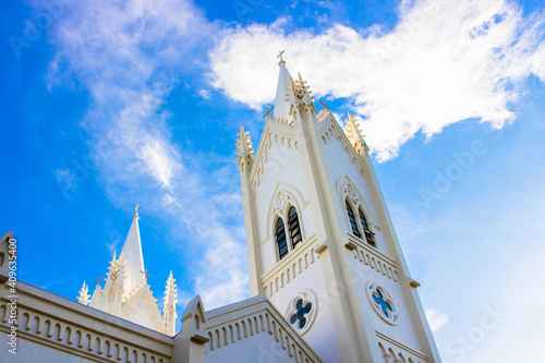 White tower of Immaculate Conception Cathedral against heaven at Puerto Princesa, Palawan island of the Philippines. photo