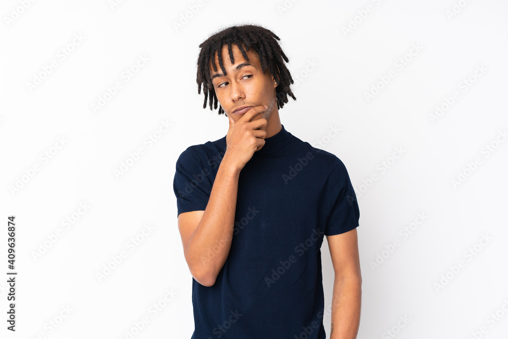 Young african american man isolated on white background having doubts and with confuse face expression Young african american man isolated on white background having doubts and with confuse face expression