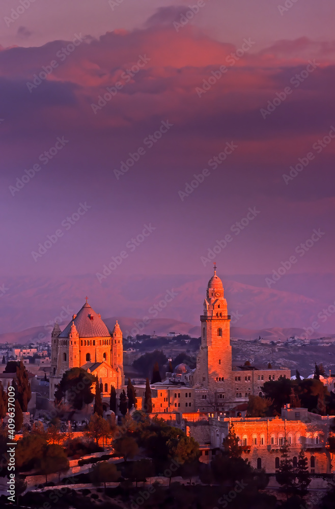 Beautiful sunset sky over the Mount Zion: the bell tower and the Benedictine church of the Dormition Abbey Basilica; Jerusalem Israel