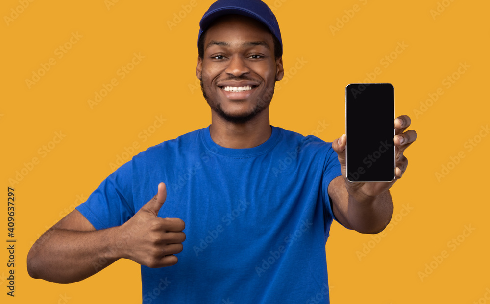 Black delivery man holding smartphone with blank screen for mockup Black delivery man holding smartphone with blank screen for mockup