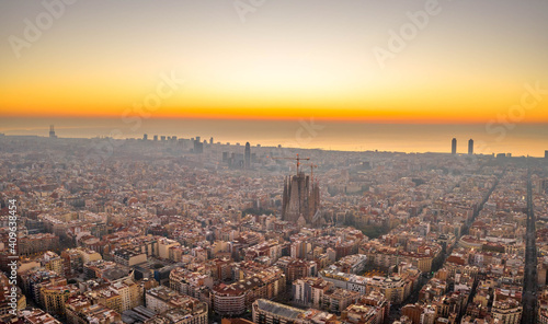 Aerial drone shot of Barcelona city center sea horizon before sunrise golden hour © Davidzfr