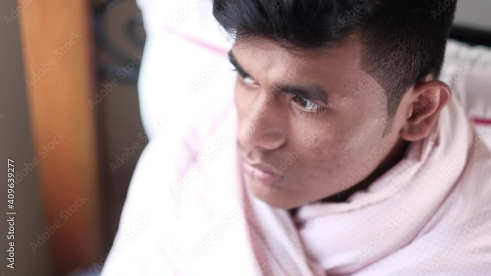 sick man with sitting on bed looking away sick man with sitting on bed looking away