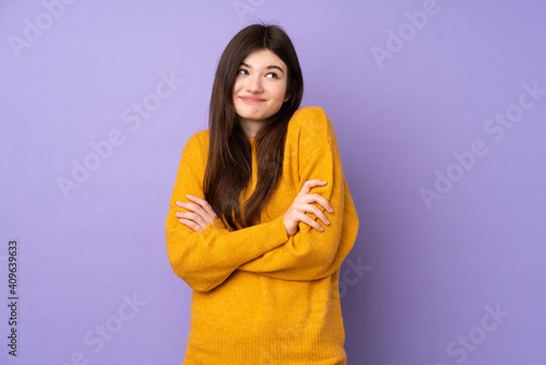 Young Ukrainian teenager girl over isolated purple background making doubts gesture while lifting the shoulders