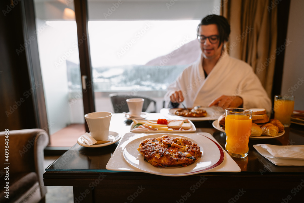 man eating breakfast in room man eating breakfast in room