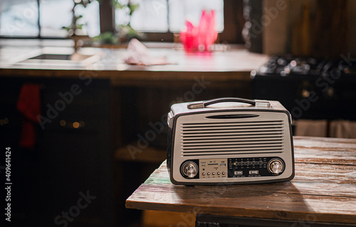 a retro radio stands on a wooden table. stylish kitchen in the village. copy space