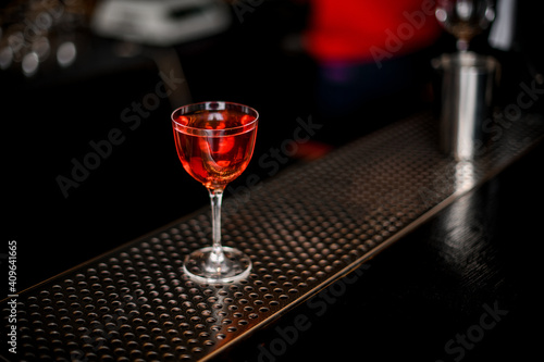 beautiful transparent glass with alcoholic drink standing on bar