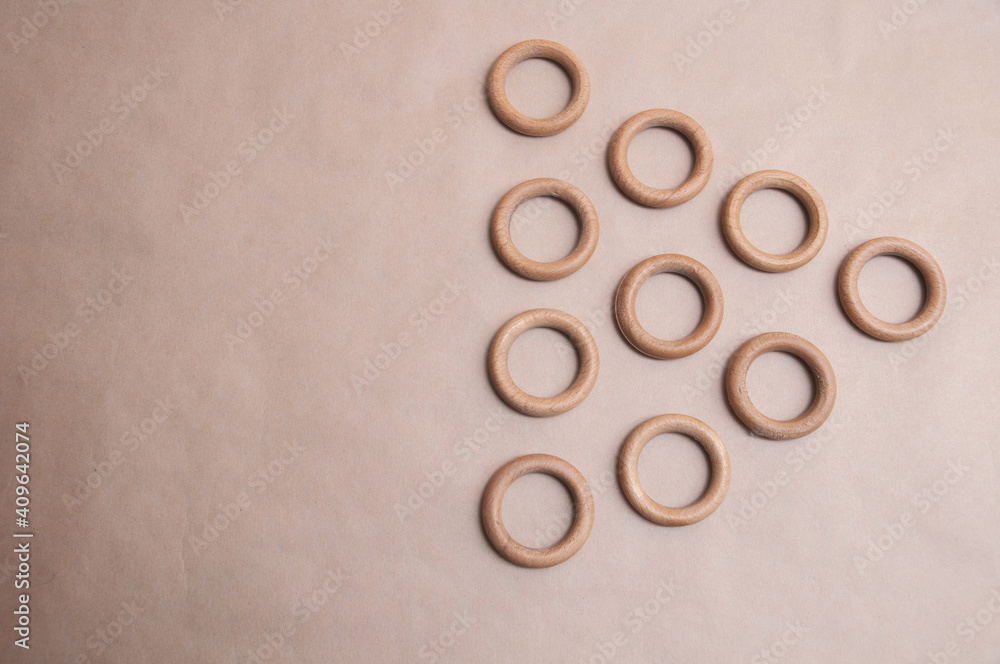 wooden rings laid out on a beige background wooden rings laid out on a beige background