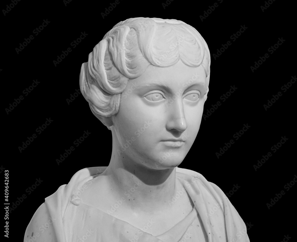 Ancient white marble sculpture bust of Faustina the Younger. Wife of Roman Emperor Marcus Aurelius. Statue of young woman isolated on black
