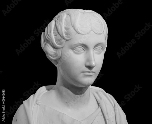 Ancient white marble sculpture bust of Faustina the Younger. Wife of Roman Emperor Marcus Aurelius. Statue of young woman isolated on black