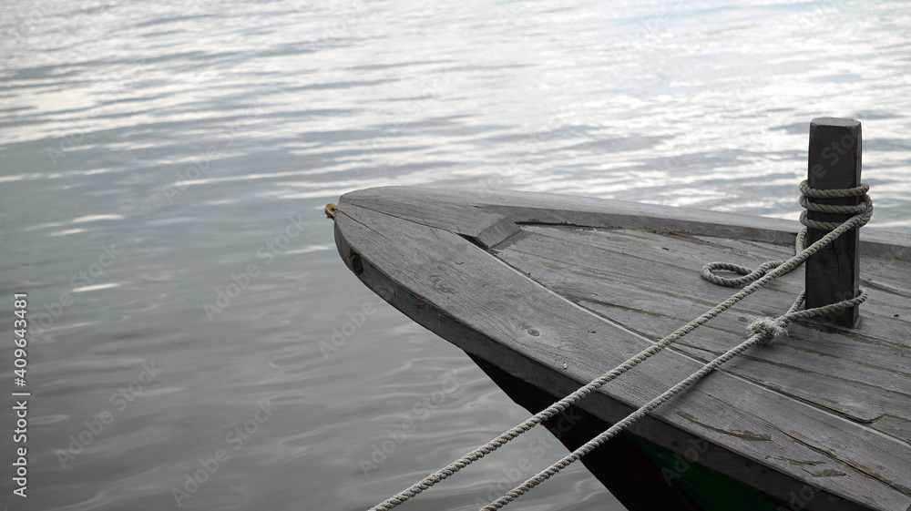 Obraz premium Moored Boat by The River