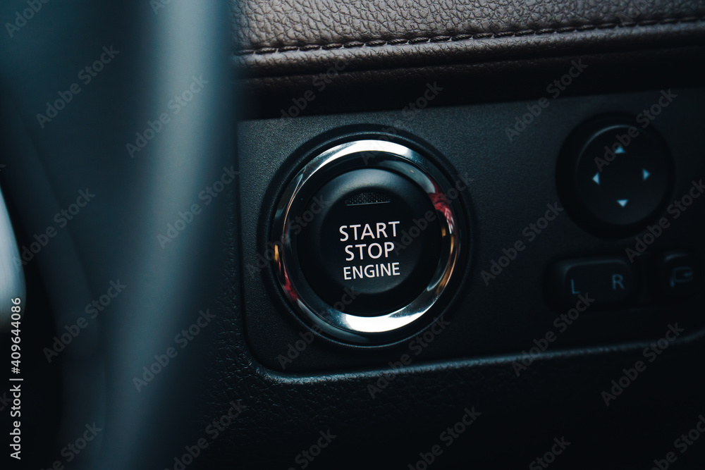 Modern car start and stop engine button - closeup of modern dashboard of modern day car, technology and safety power button. Modern car start and stop engine button - closeup of modern dashboard of modern day car, technology and safety power button.