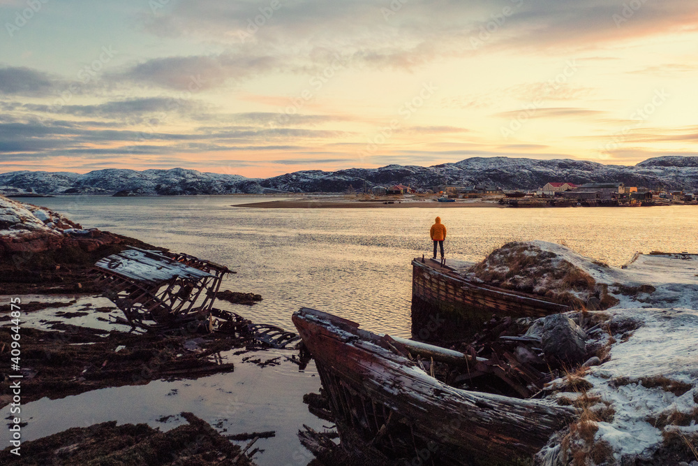 Graveyard of ships, winter sunset view in an old fishing village on the shore of the Barents sea, the Kola Peninsula, Teriberka Graveyard of ships, winter sunset view in an old fishing village on the shore of the Barents sea, the Kola Peninsula, Teriberka