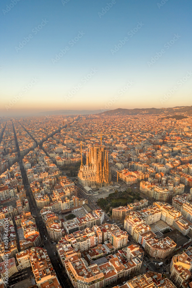 Aerial drone shot of Barcelona city before sunrise golden hour