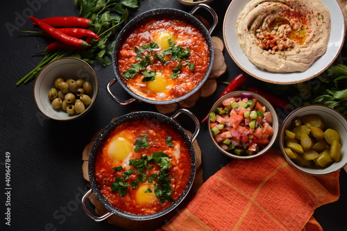 Shakshouka, eggs poached in sauce of tomatoes, olive oil, peppers, onion and garlic, Mediterranean cuisine