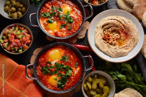 Shakshouka, eggs poached in sauce of tomatoes, olive oil, peppers, onion and garlic, Mediterranean cuisine
