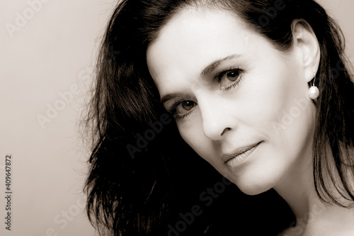 Fotografie Portrait of a mature brunette woman sitting and contemplates realities of life