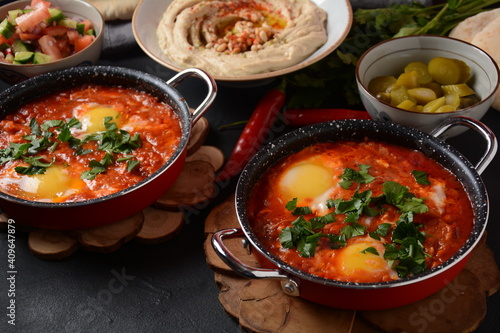 Shakshouka, eggs poached in sauce of tomatoes, olive oil, peppers, onion and garlic, Mediterranean cuisine