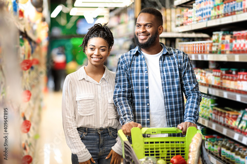 Happy African American Family Doing Groceries Shopping In Supermarket Together