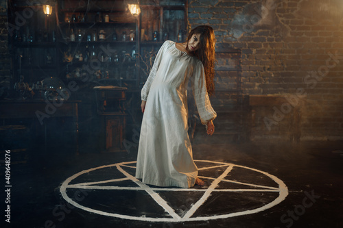 Obraz na plátně Creepy demonic woman standing in the magic circle